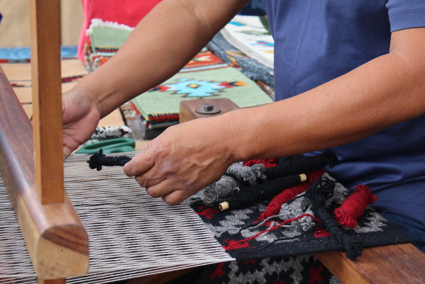 Zapotec weaver Mel Mendez works at the loom during the Golden Fine Arts Festival Aug. 20 in downtown Golden. Mendez, who's from Prescott, Arizona, was the featured artist at this year's festival. The posters and T-shirts for the 32nd annual event feature his rug titled "Contemporary Fish."